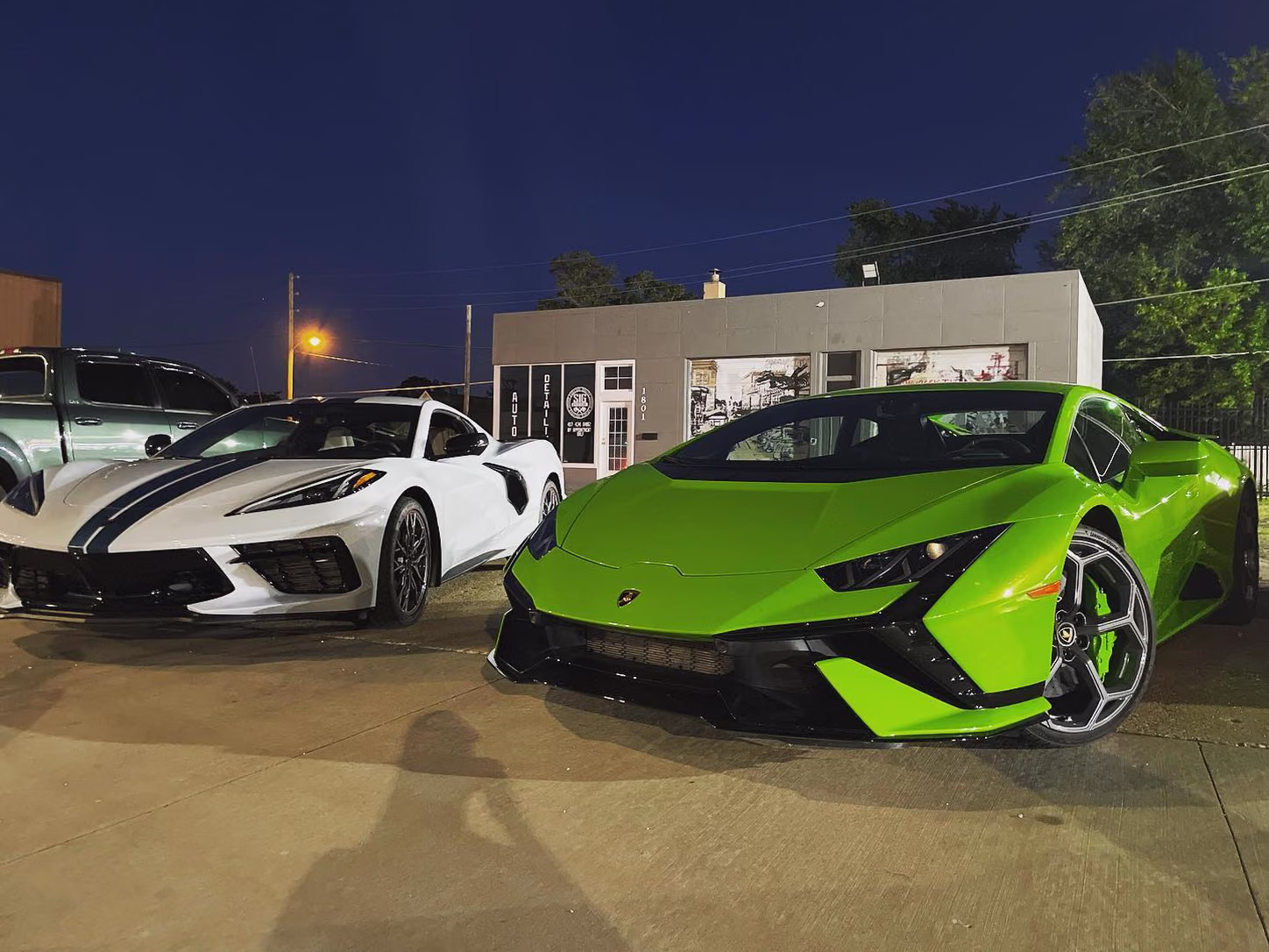 Corvette and Huracán outside the shop at dusk